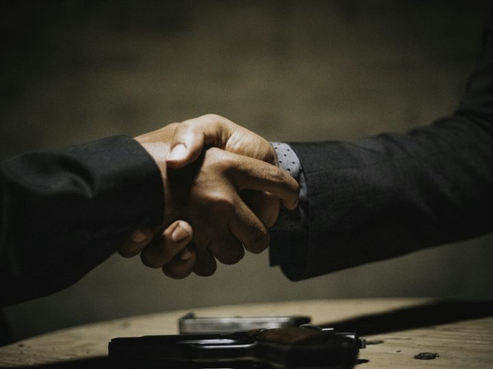 Handshake over a wooden table