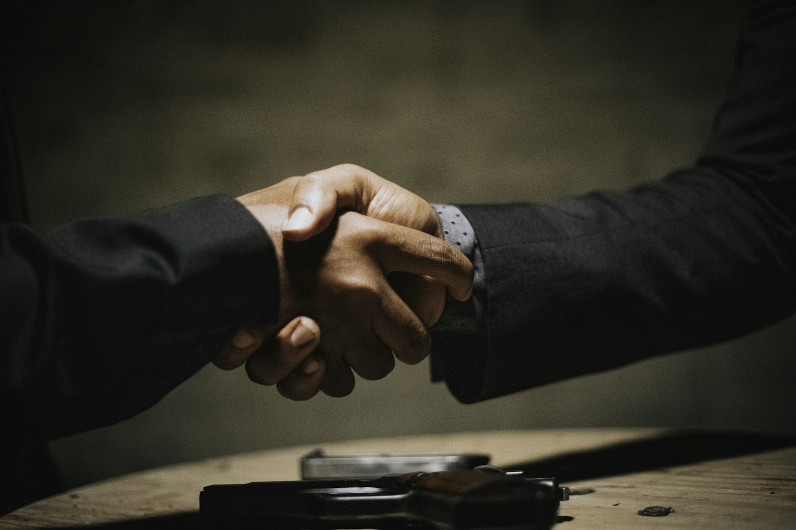 Handshake over a wooden table