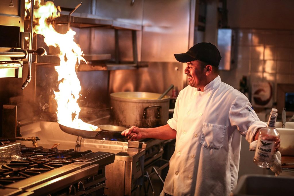 Chef at a flaming stove
