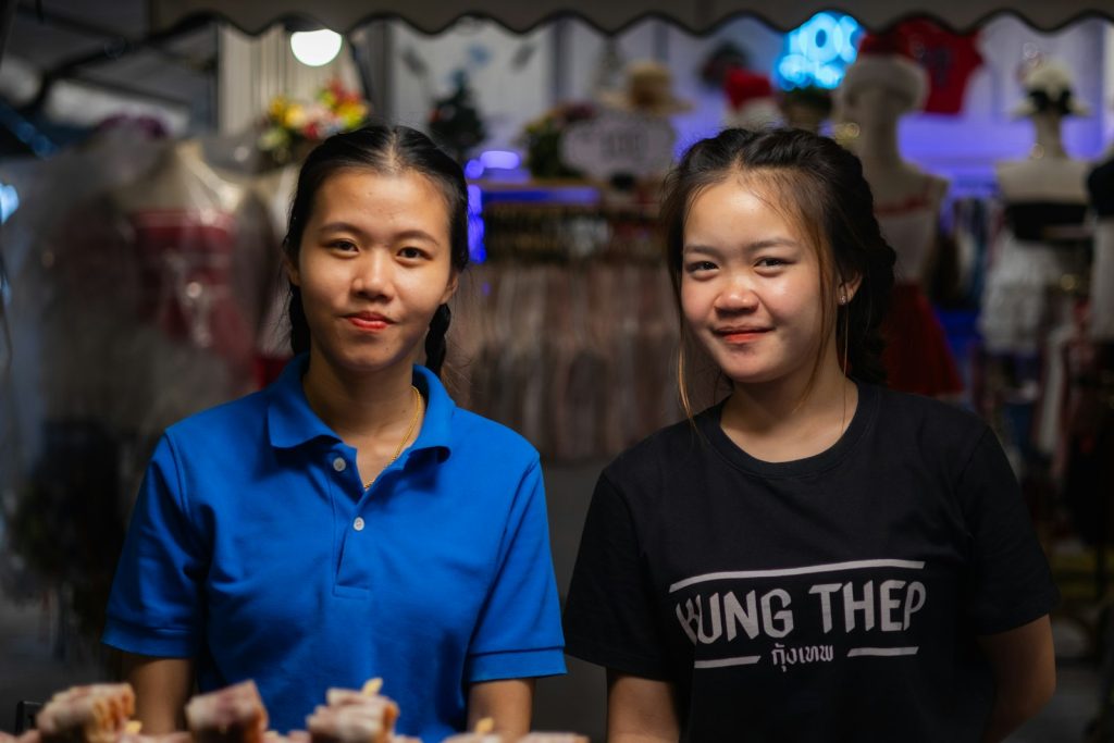 Two shop staff behind a retail counter