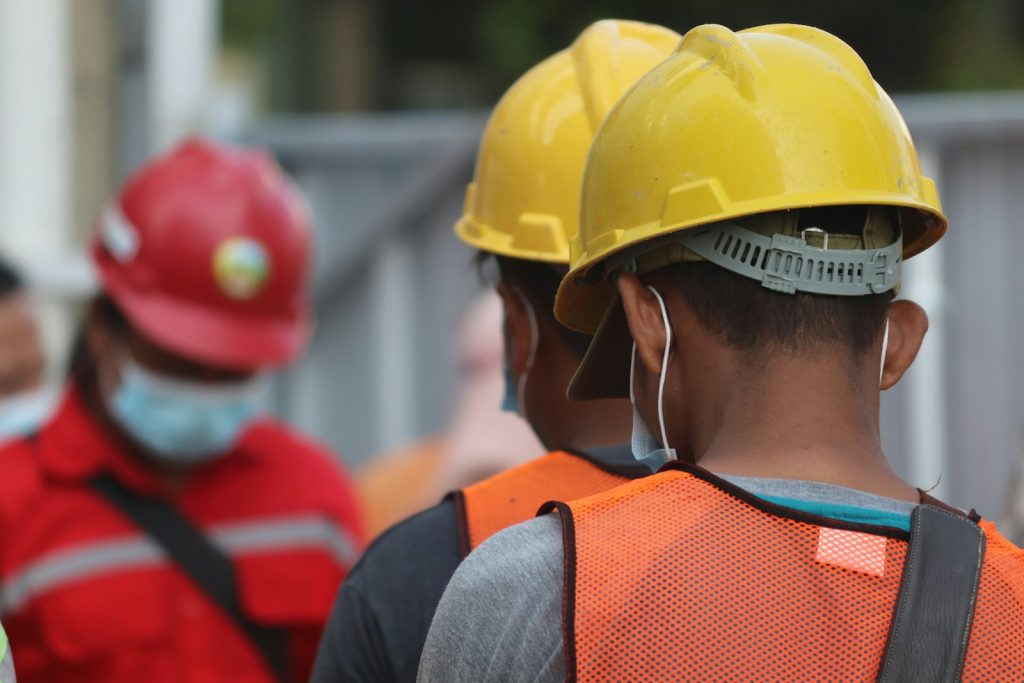 Asian construction worker, yellow helmet + mask