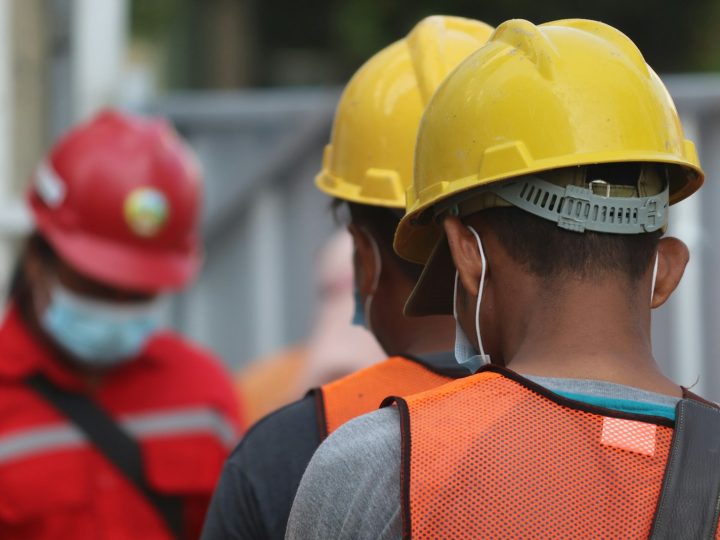 Asian construction worker, yellow helmet + mask