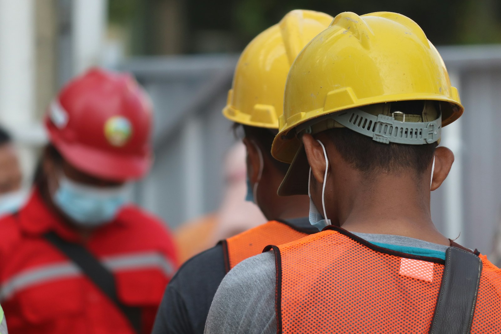 Asian construction worker, yellow helmet + mask