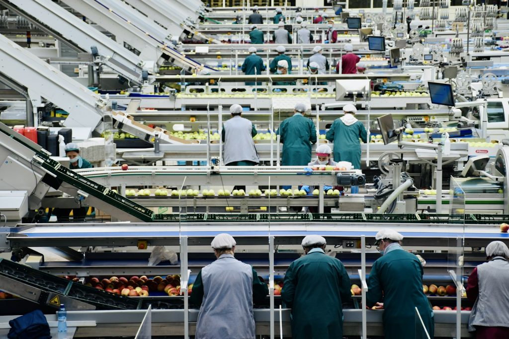 Food-production line workers in hairnets, Asian